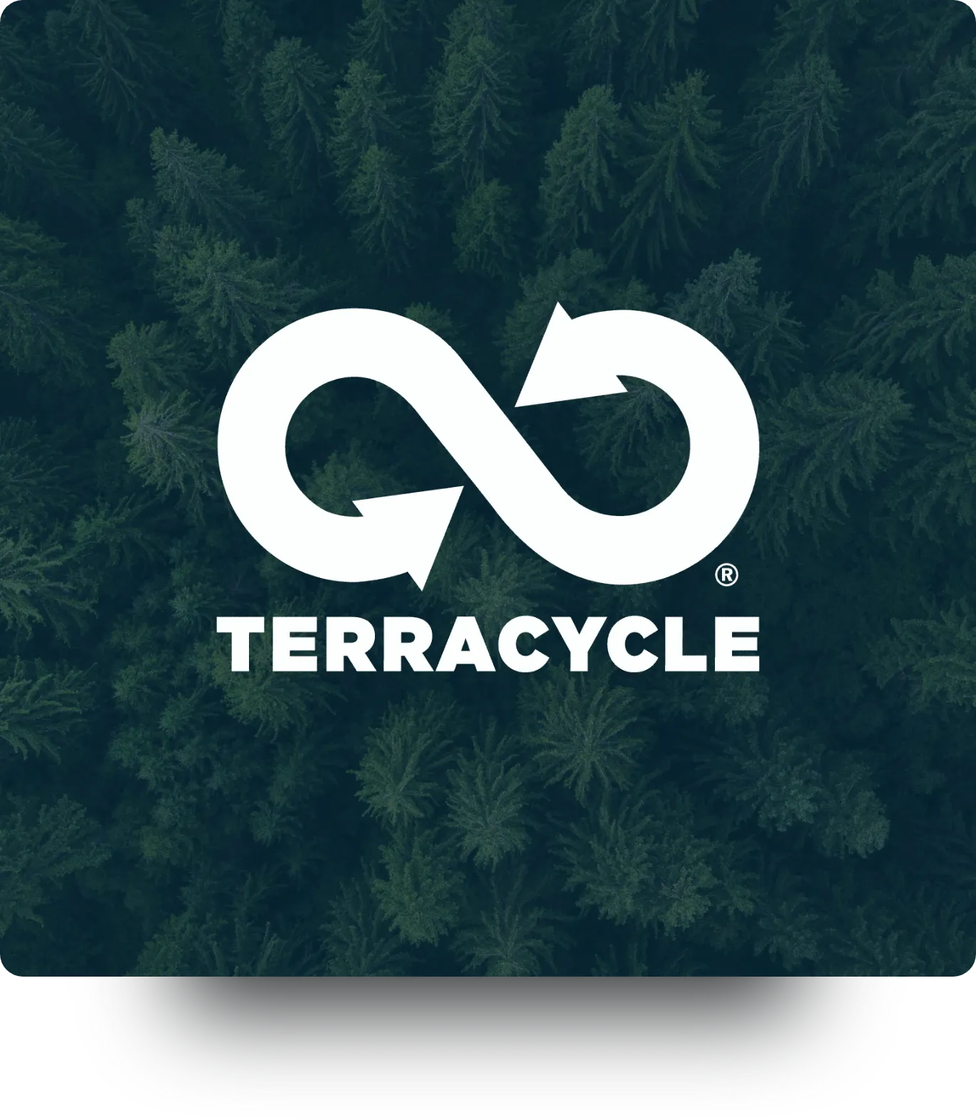 A man in bed, looks at his illuminated phone.